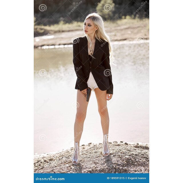 Photos - Blonde Woman With A Gun In Her Hands. Spy Girl In Short Shorts A